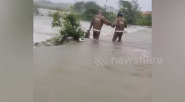 Policemen rescue villager being swept away by flood in India