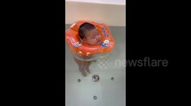 China: A Baby is Enjoying Swimming
