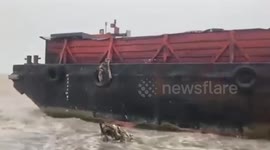 Barge runs aground as Tropical Storm Yagi churns up huge waves in the Philippines