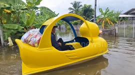 Council chief uses bright yellow duck pedalo to deliver aid to flood-striken residents