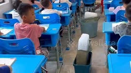 Ice blocks carried into classrooms to help young students cope with severe heat in China