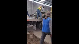 Man with one leg unloads truck using crutch in Guatemala