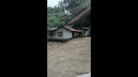 Flash flood surges along river as Tropical Storm Yagi batters the Philippines