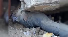Gazans trying to pull out a slain Palestinian from under the rubble