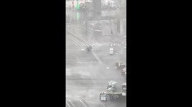 Market vendors frantically chase stalls being blown away by storm