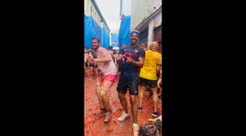 Festival-Goer Enjoys Cheery Mayhem of La Tomatina as he Joins in the Tomato Chaos
