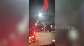 Swarm of mayflies take over bridge in China - creating a slippery snow-like surface
