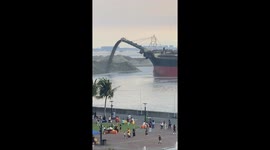 Ship dumps sand to extend shore in Manila