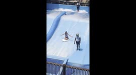 Surf Pool Attendant Is Prepared For Woman's Wipeout