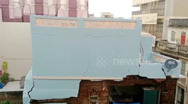 Locals watch on as house collapses amid heavy rain in western India