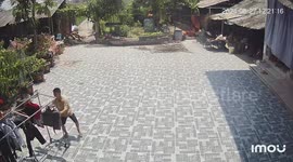 Boy dances like a Spaghetti Western cowboy as he moves clothes across hot floor