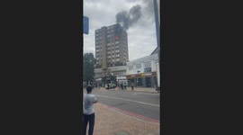 Flames burst out windows as firefighters battle blaze at apartment block in Catford