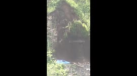 Quick-thinking driver reverses away from landslide falling onto car