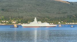 HMS Cardiff leaving Loch Long in Argyll Scotland after being floated off her barge