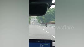 Scary moment riderless motorbike travels down road in front of car