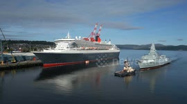 5 Sept 2024. HMS Cardiff passes Queen Mary 2 at Greenock en route to BAE shipyard in Scotstoun, Glasgow, UK