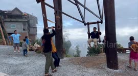 Hill tribe families show off wooden swings in remote northern Thailand