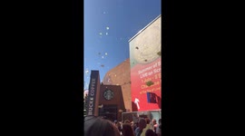 People gathering to see a foam party in liverpool one. Lots of people in were confused about what was going on only to find lots of coloured foam floating around