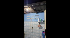 Neighbour helps a family to remove huge python from their bathroom