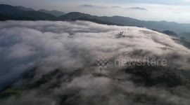 Sea of clouds flows over Jiyun Mountain in China