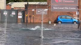 Busy city street turned into 'a river' after burst water main causes flood chaos