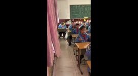 Schoolboy draws fake eyes on his face pretending to be awake during class