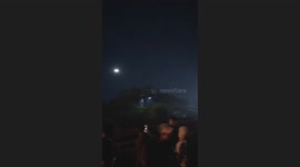 Train passes through large fire near tracks in West Java