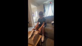 Boy cries while holding a cuddly toy with grandma’s photo and a special message