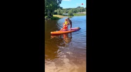 Kids and mom take an unplanned dive during a hilarious attempt at standup paddleboarding