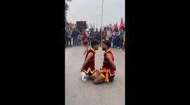 Blindfolded person successfully cuts banana between two people in Haryana, India