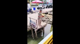 Drink spills during tray hand-off on boat