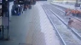Incredible moment woman trapped between platform and train saved by station guard