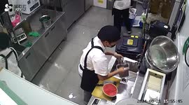 Restaurant kitchen shelves collapse as chef prepares watermelon