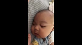 Chinese baby smiles in sleep after hearing mother's laughter