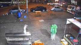 Fast food stall pushed down road by strong wind in China