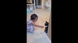 Toddler's adorable giggles while playing with gentle kitten will melt your heart