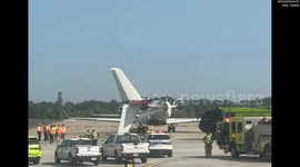 Images show plane's tail hanging off its side after collision at Atlanta airport