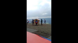 Flying house! Paraglider inside SHED floats across valley