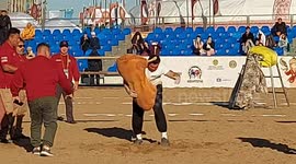 Kazakhstan's Azamat Makulbekov lifting the 100 kg bag in the Powerful Nomad competition at the World Nomad Games in Astana, Kazakhstan