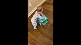 Baby Tumbles Over Diaper Box