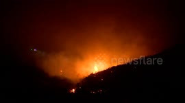 Helicopters battle wildfire in Mentone, California, USA