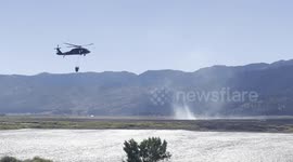 Firefighting helicopter scoops up water from lake to help extinguish Davis Fire in California