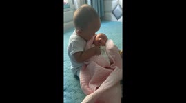Heartwarming moment Chinese toddler babysits his newborn sister