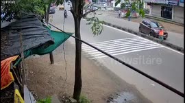 Street sweeper hit by car and pushed over divider