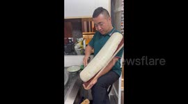 China: A Chef making Daoxiao Noodles