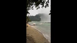 Spectacular rain microbrust moves onto beach
