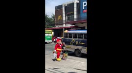 Fast food mascot helps elderly woman cross road