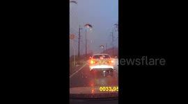 Lightning strikes power pole just metres away from passing traffic in Japan