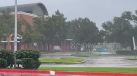 Street sign wobbles in strong winds of Hurricane Francine