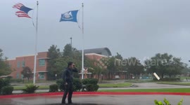 Man struggling to stand in the strong winds of Hurricane Francine